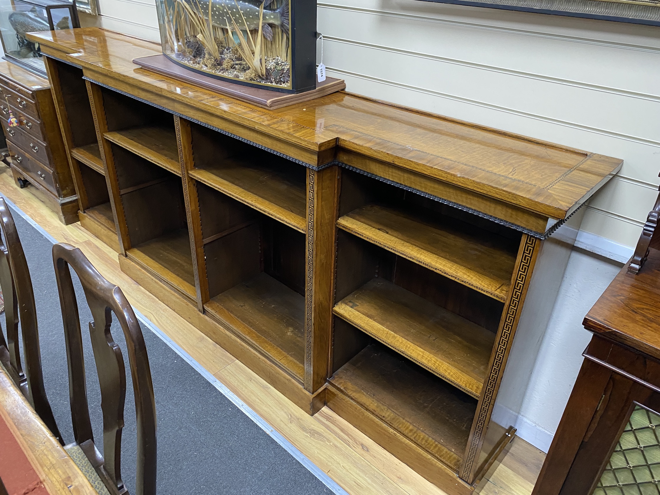 A Regency style banded inlaid walnut breakfront dwarf bookcase, width 266cm, depth 45cm, height 109cm